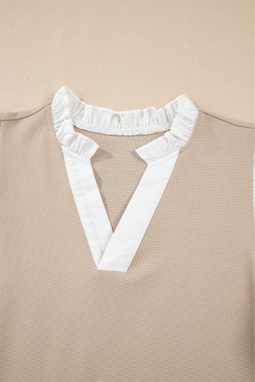 Khaki blouse with white contrast ruffle collar and V-neck detail.