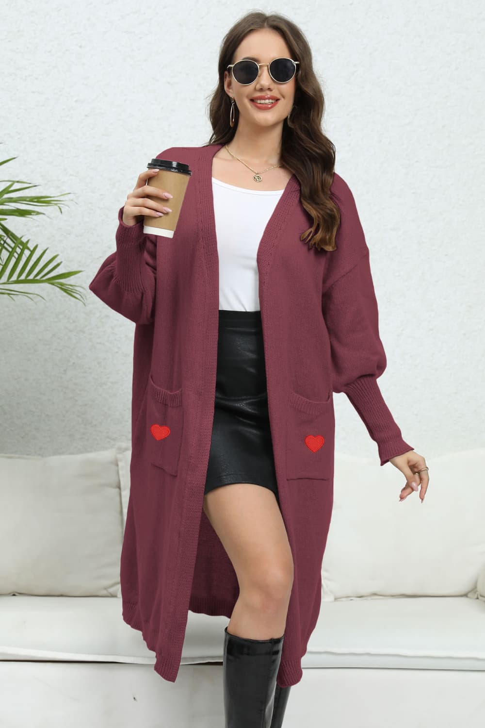 Burgundy long cardigan with balloon sleeves and embroidered red hearts on pockets.
