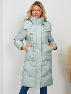 Sage quilted puffer parka with buckle detail and large hood.