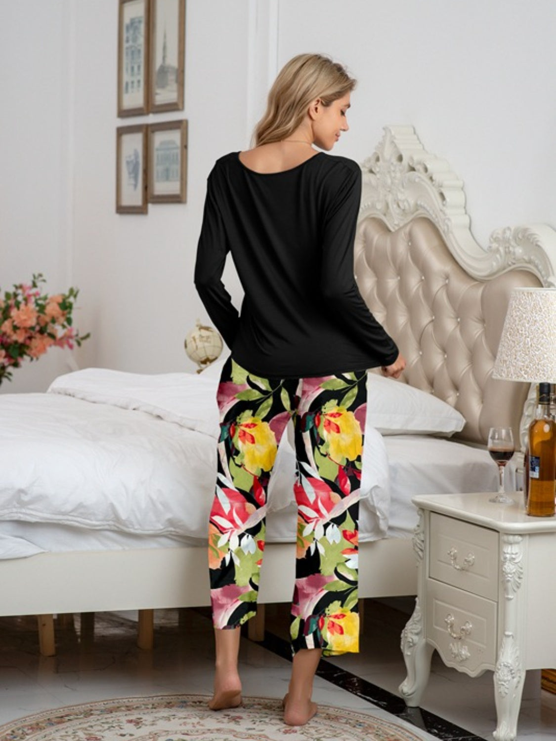 Botanical print lounge set with long sleeve black top and cropped pants.