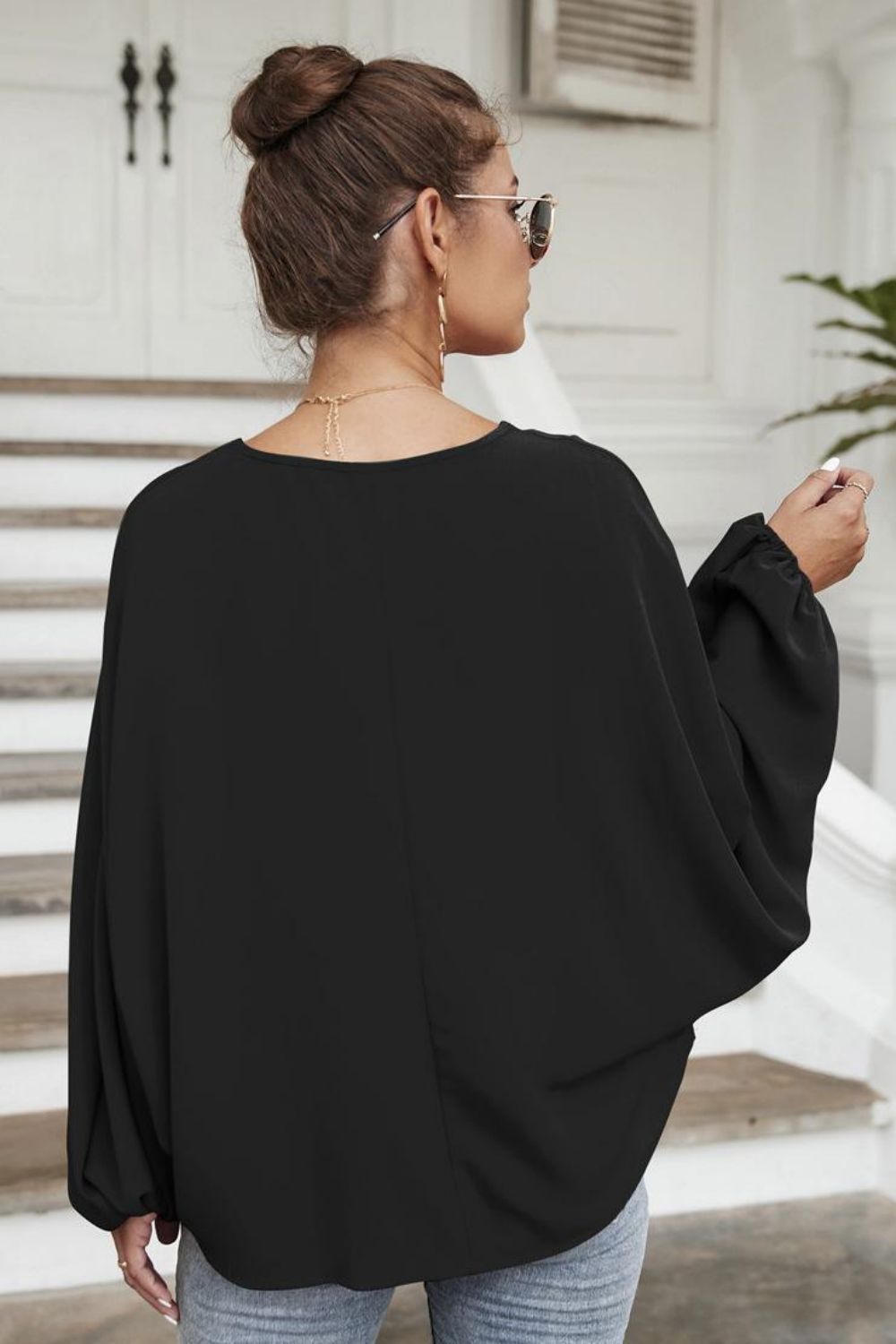 Black voluminous sleeve blouse with gathered cuffs and a keyhole neckline detail.