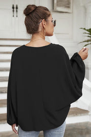Black voluminous sleeve blouse with gathered cuffs and a keyhole neckline detail.