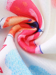 Toddler dress with rainbow butterfly print, featuring pink, orange, blue, and white colors.