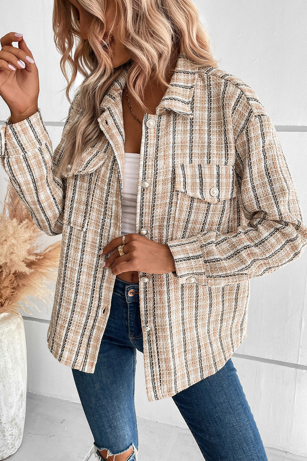 Textured tweed shirt jacket in tan with pockets and button front.