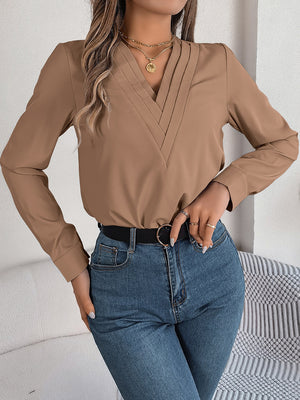 Camel V-neckline blouse with subtle pleats and long sleeves.