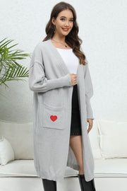 Light gray balloon sleeve cardigan with a red heart pocket detail.