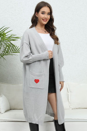 Light gray balloon sleeve cardigan with a red heart pocket detail.