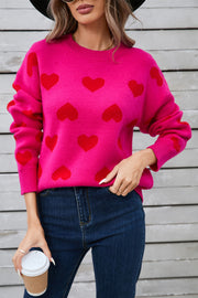 Hot Pink acrylic sweater with allover red heart intarsia pattern, crew neck, long sleeves.