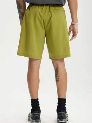 Men's olive green chino shorts with drawstring waist and relaxed fit.