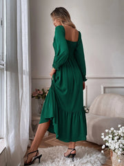 Green midi dress with smocked bodice, puff sleeves, and ruffled hem.
