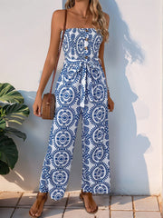 Bustier print wide leg jumpsuit in blue and white with decorative buttons and tie waist.