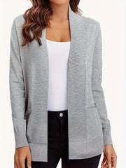 Gray textured knit open-front cardigan with pockets, styled with a white tank top and black pants.