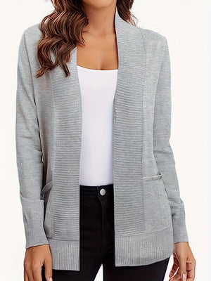 Gray textured knit open-front cardigan with pockets, styled with a white tank top and black pants.