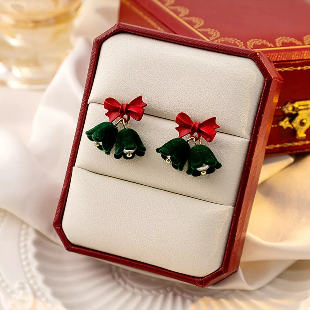 Dark green velvet bell earrings with red bows, featuring gold accents.