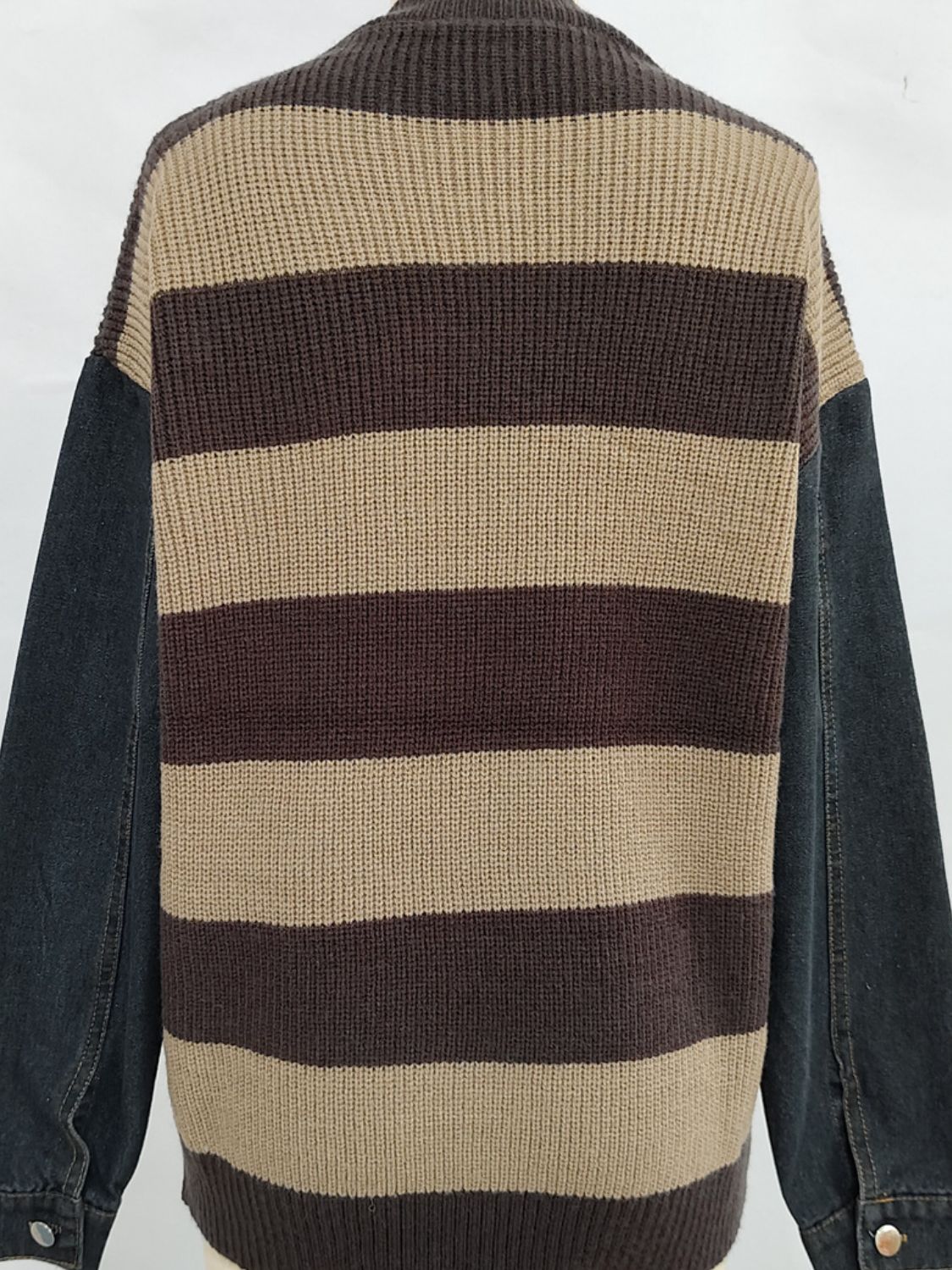 Brown and tan striped knit sweater with black denim sleeves.