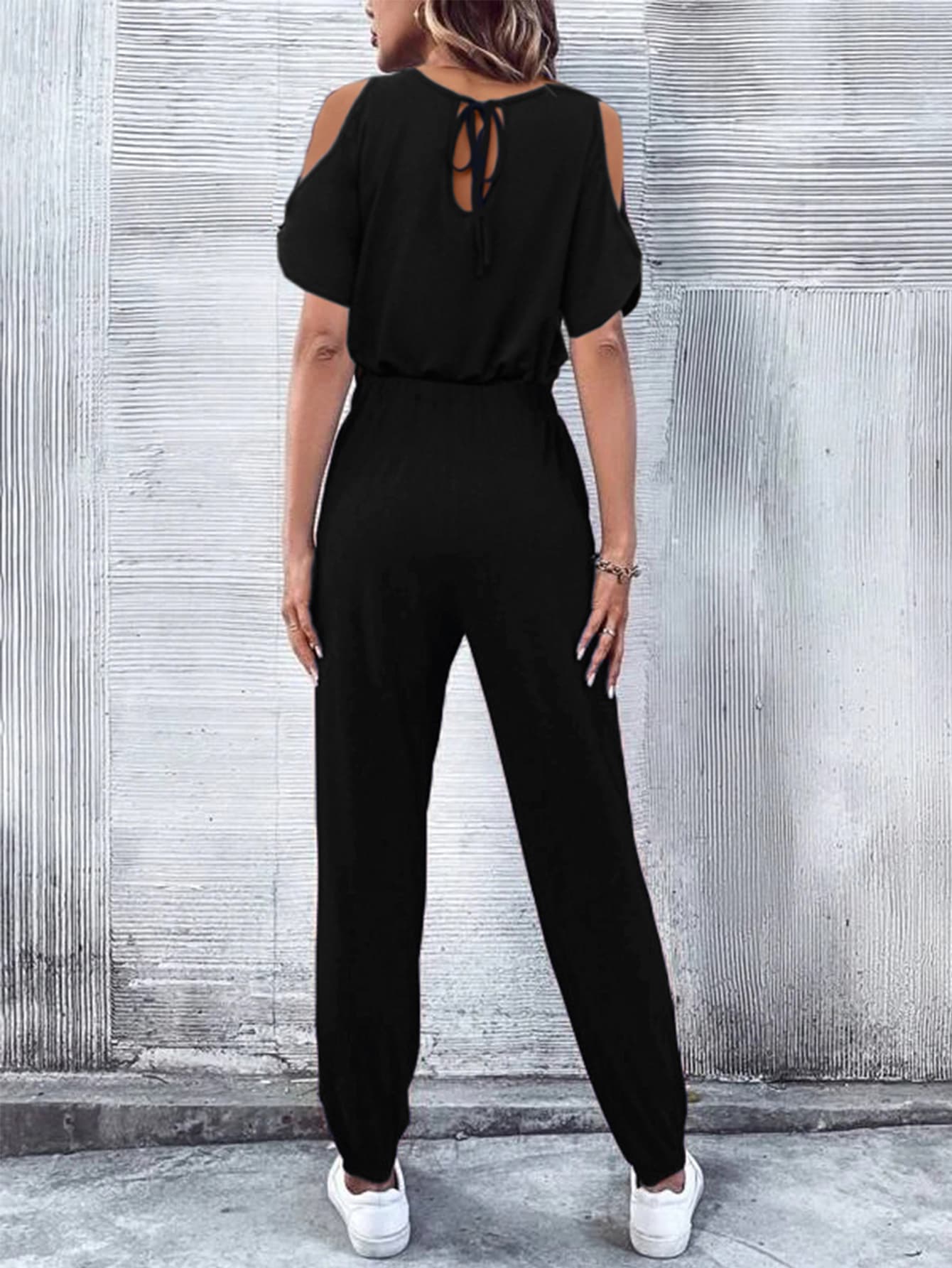 Black cold-shoulder jumpsuit with drawstring waist and tie back detail