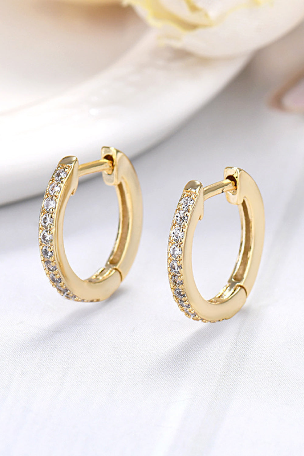 Gold pavé hoop earrings with clear stones, 18K gold-plated sterling silver.