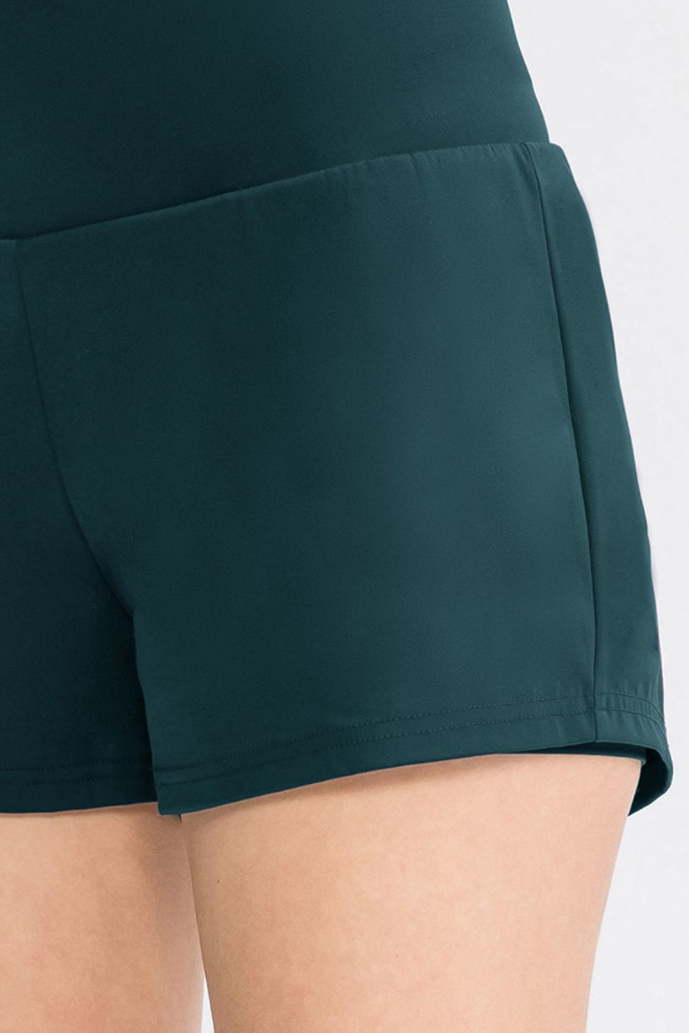 Sculpted high-waist active shorts in deep teal with a smooth finish and comfortable fit.