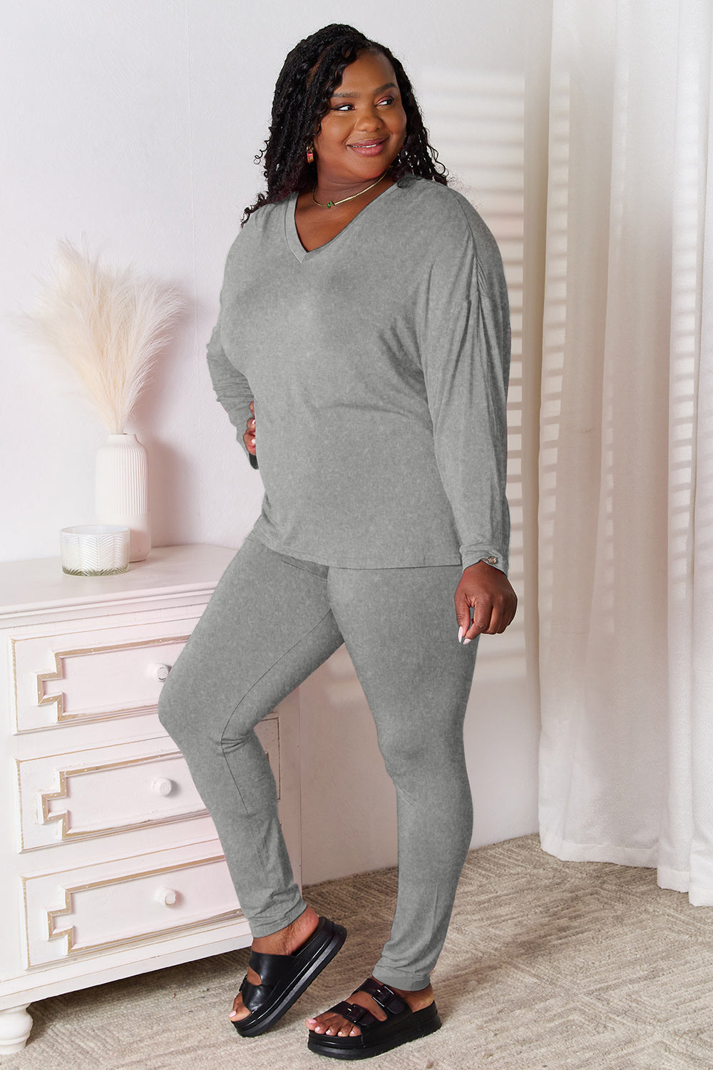 Gray relaxed knit loungewear set with V-neck long sleeve top and fitted pants.