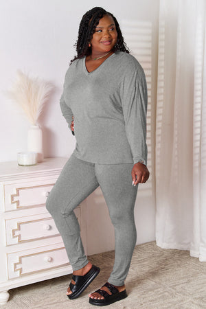 Gray relaxed knit loungewear set with V-neck long sleeve top and fitted pants.