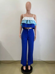 Chic layered ruffle crop top set in blue with white and light blue tiers, paired with wide-leg pants.
