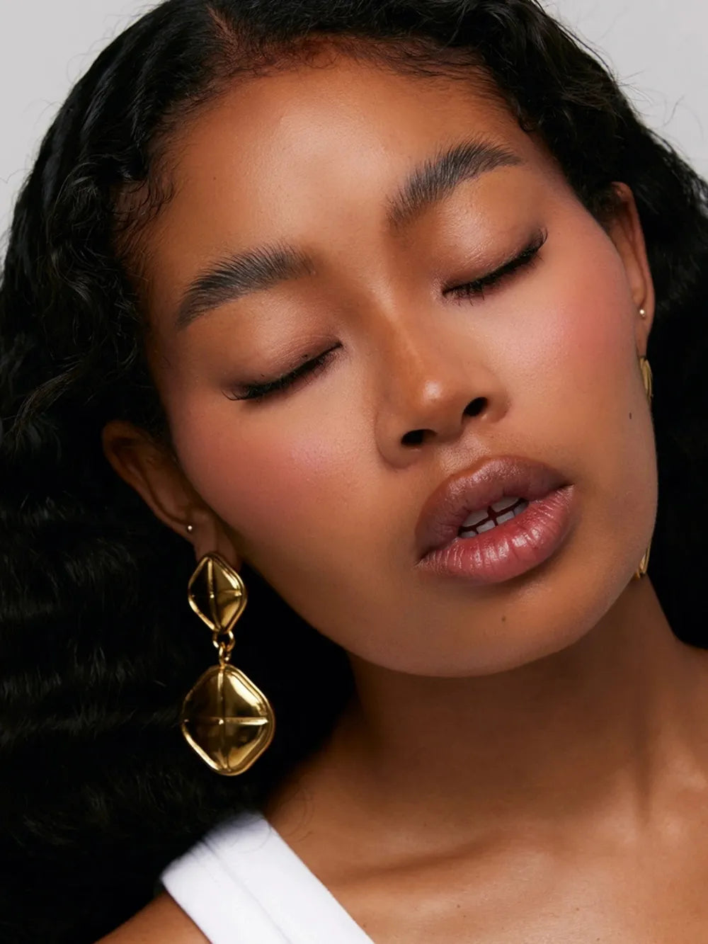 Sculpted Geo Drop Earrings in gold feature two stacked diamond shapes with a textured surface.