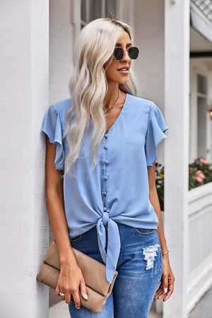Pastel blue tie-front blouse with ruffle sleeves and button detail