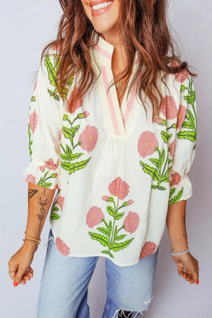 Vibrant floral cotton blouse with ruffled sleeves and notched neckline.