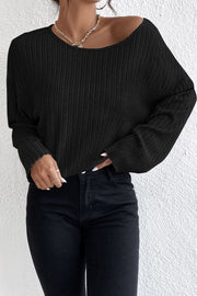 Black off-shoulder ribbed knit top with long sleeves and a lettuce hem detail.