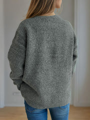 Dark Gray acrylic knit sweater with crew neck and long sleeves, styled with jeans.
