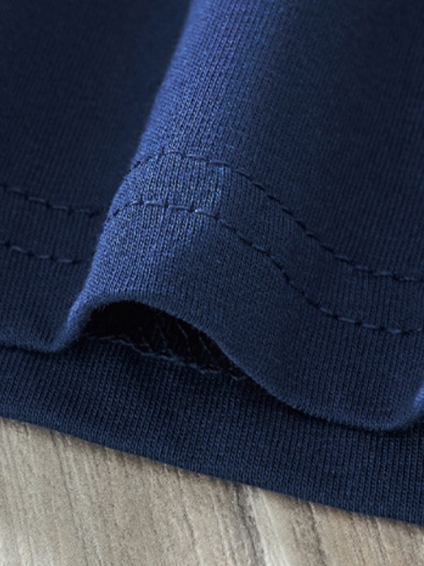 Dark navy crew neck toddler t-shirt showing stitched hem detail.