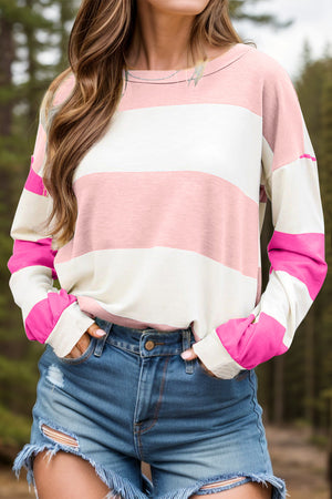 Striped sweatshirt in blush pink and white with hot pink block sleeves and a crew neck.