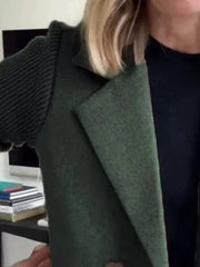 Double-breasted trench coat in dark green with ribbed knit sleeves and notched lapel.