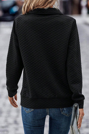 Black diamond quilted zip-neck pullover sweatshirt with long sleeves.