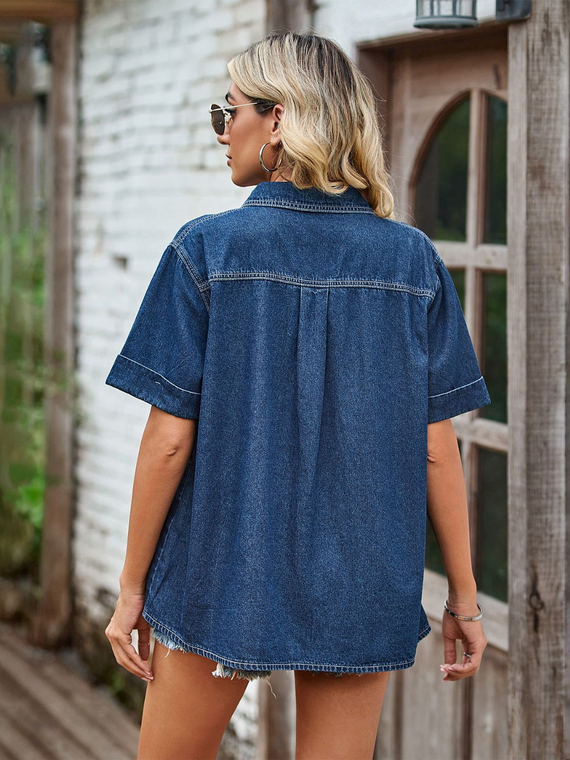 Boxy dark blue denim shirt with short sleeves and a relaxed fit.