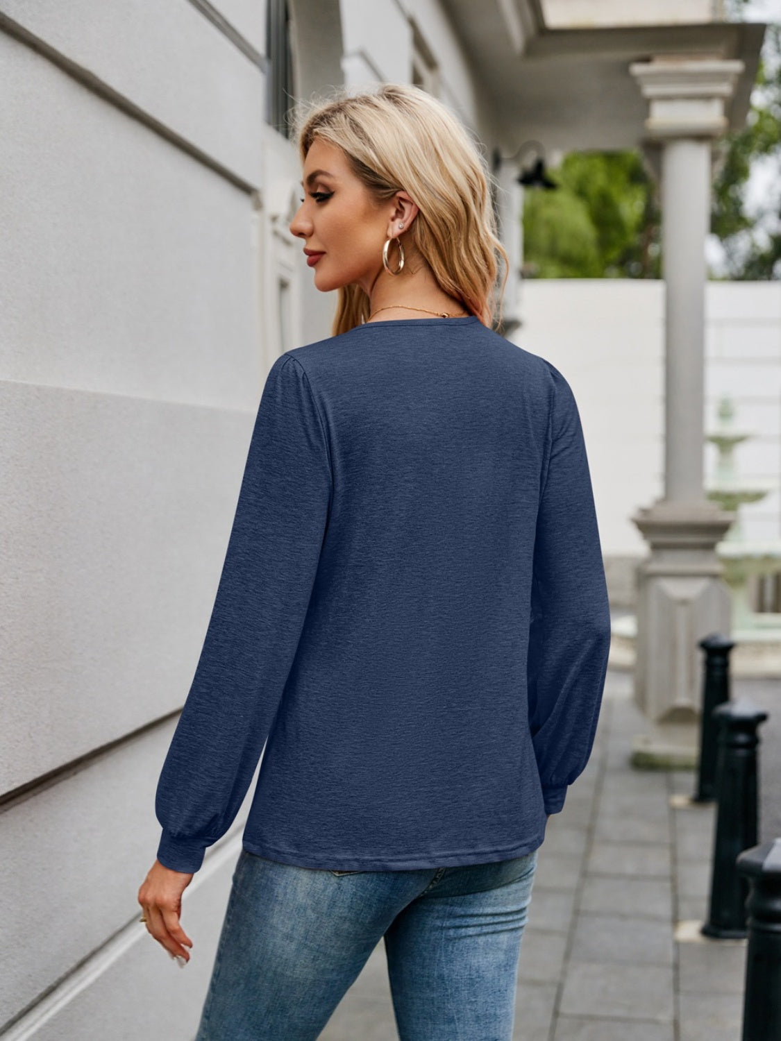 Navy long sleeve blouse with gathered sleeves and a textured finish.
