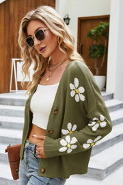 Green knit button-down cardigan with white daisy embroidery and yellow centers.
