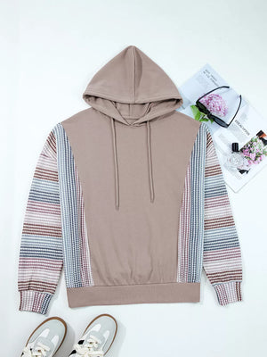Relaxed fit cotton hoodie with multi-tonal patterned sleeves and drawstring hood.
