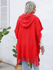Red knit poncho with fringe, hood, and cable knit detail.