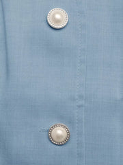 Blue buttoned vest detail with pearl and chain buttons