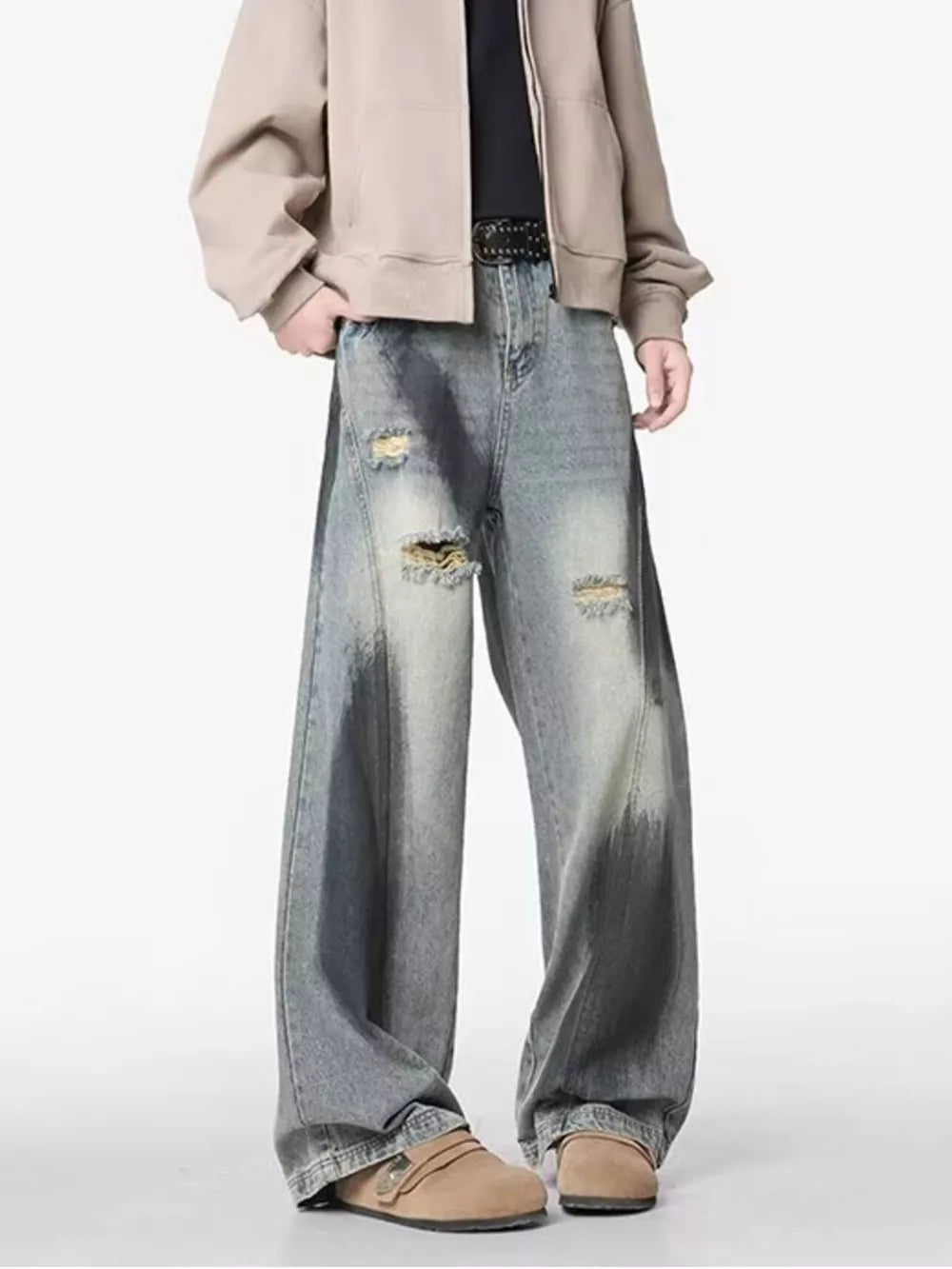 Distressed wide-leg jeans with belted detail and faded wash.