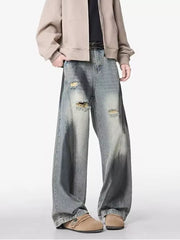 Distressed wide-leg jeans with belted detail and faded wash.