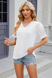 White tee with tie-neck, puffed short sleeves with ruffled cuffs.