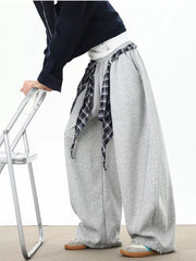 Grey relaxed fit wide-leg sweatpants with plaid tie detail.