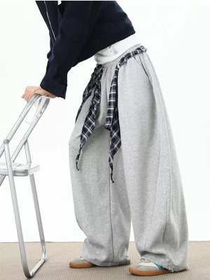Grey relaxed fit wide-leg sweatpants with plaid tie detail.