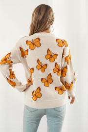 Beige acrylic knit crewneck pullover sweater with allover orange butterfly motif.