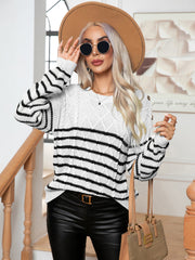 White cable-knit sweater with black stripes and shoulder buttons