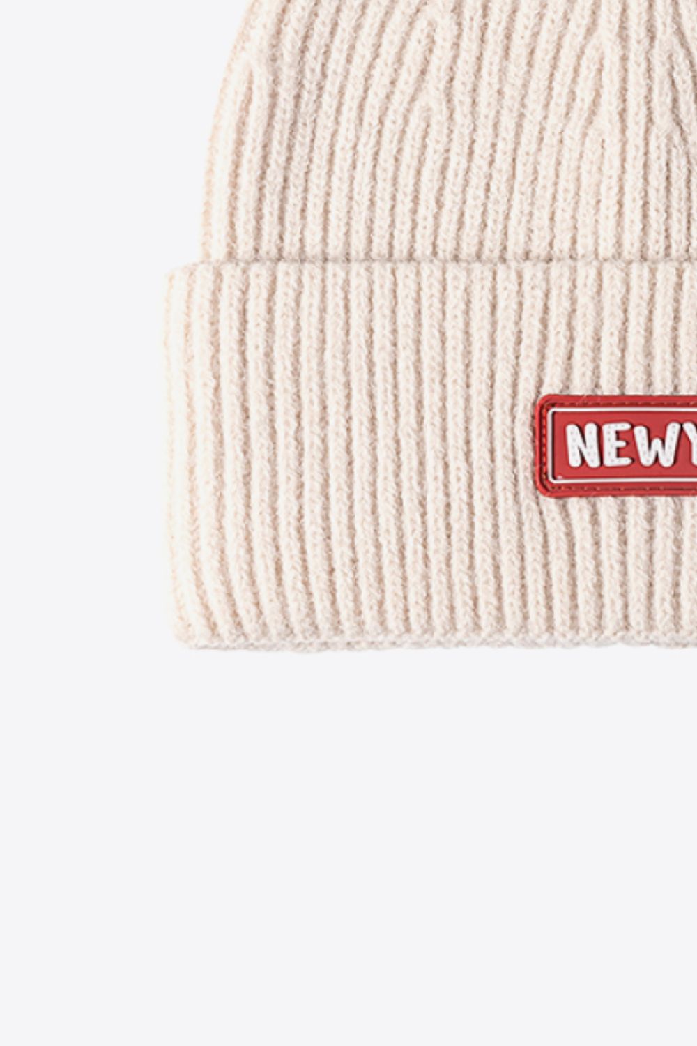 Beige ribbed acrylic beanie with New York patch detail