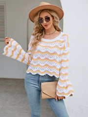 White crochet sweater with orange-red wavy stripes and bell sleeves.