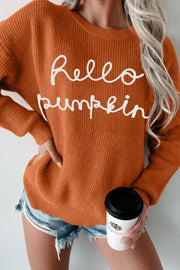 Terracotta knit sweater with white "Hello Pumpkin" script, crew neck, long sleeves.